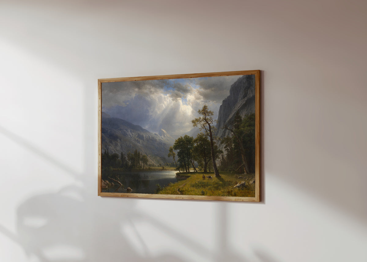 Framed art print of Mount Starr King by Albert Bierstadt, in a light wood frame on a sunlit white wall, seen at a slight angle