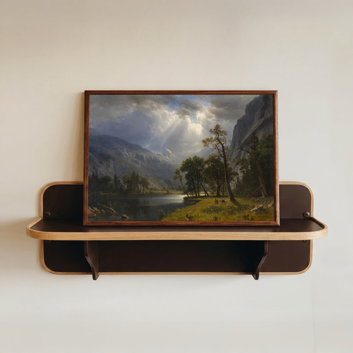 Framed art print of Mount Starr King by Albert Bierstadt, in a dark wood frame resting on a wall shelf
