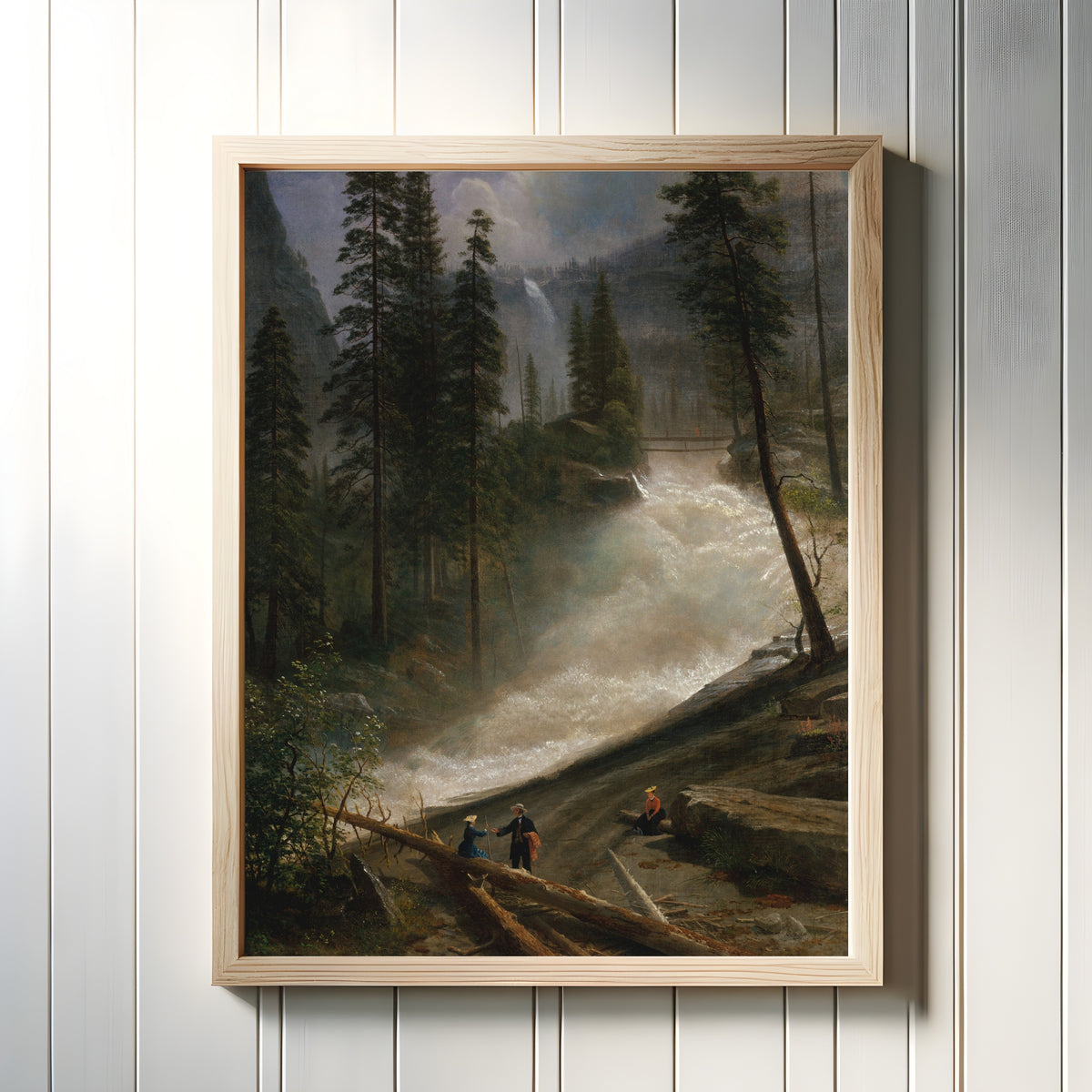 Framed art print of Nevada Falls, Yosemite by Albert Bierstadt, in a light wood frame on a white panelled wall