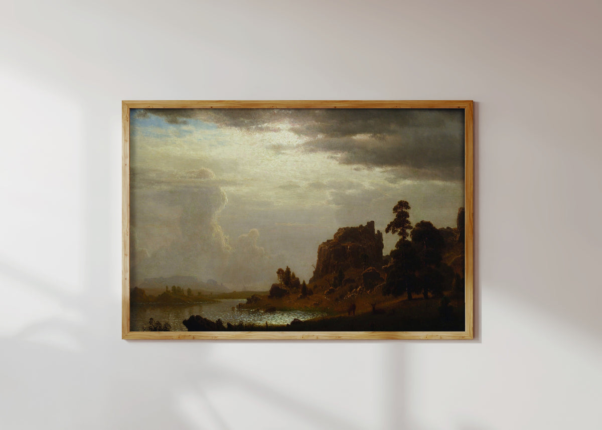 Framed art print of On the Sweetwater near the Devil's Gate by Albert Bierstadt, in a light wood frame on a sunlit white wall