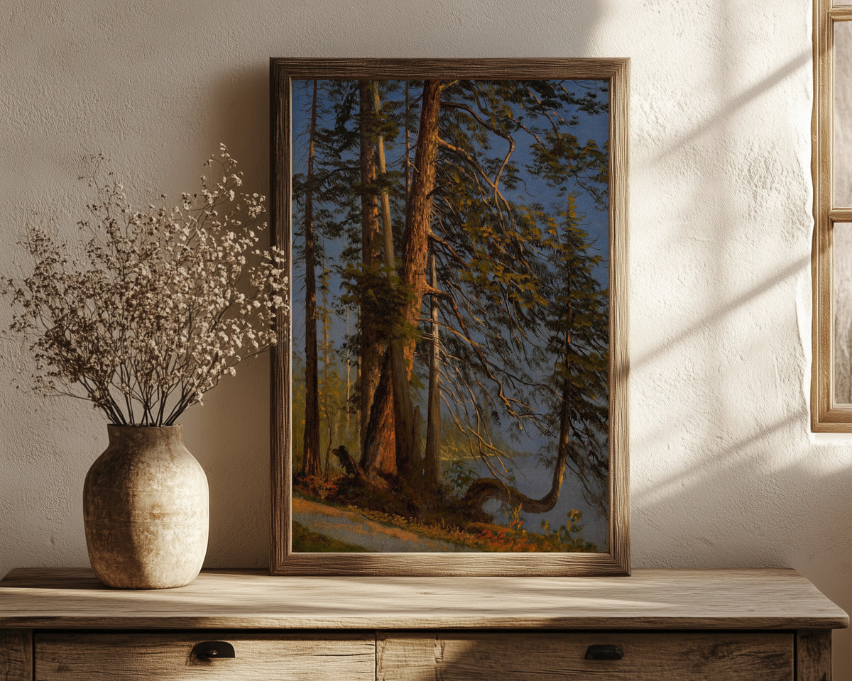 Framed art print of Park at Vancouver by Albert Bierstadt, in a dark wood frame leaning on a rustic console beside dried flowers