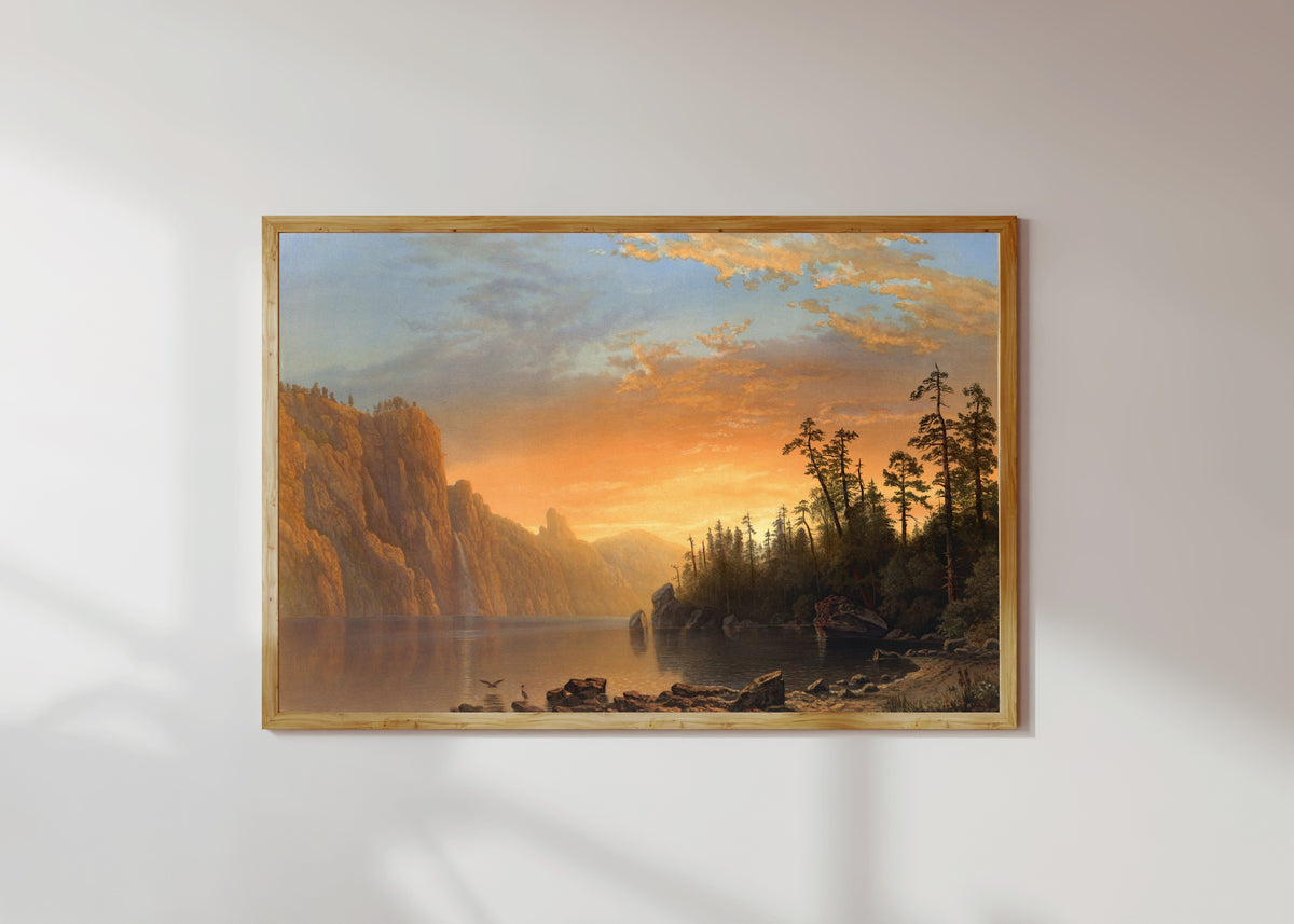 Framed art print of Sunset in California by Albert Bierstadt, in a light wood frame on a sunlit white wall