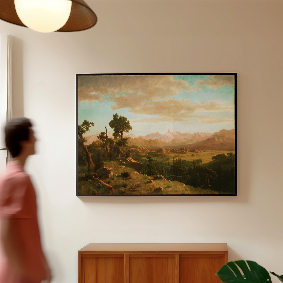 Framed art print of Wind River Country by Albert Bierstadt, in a slim black frame on a warm wall in a sunlit room