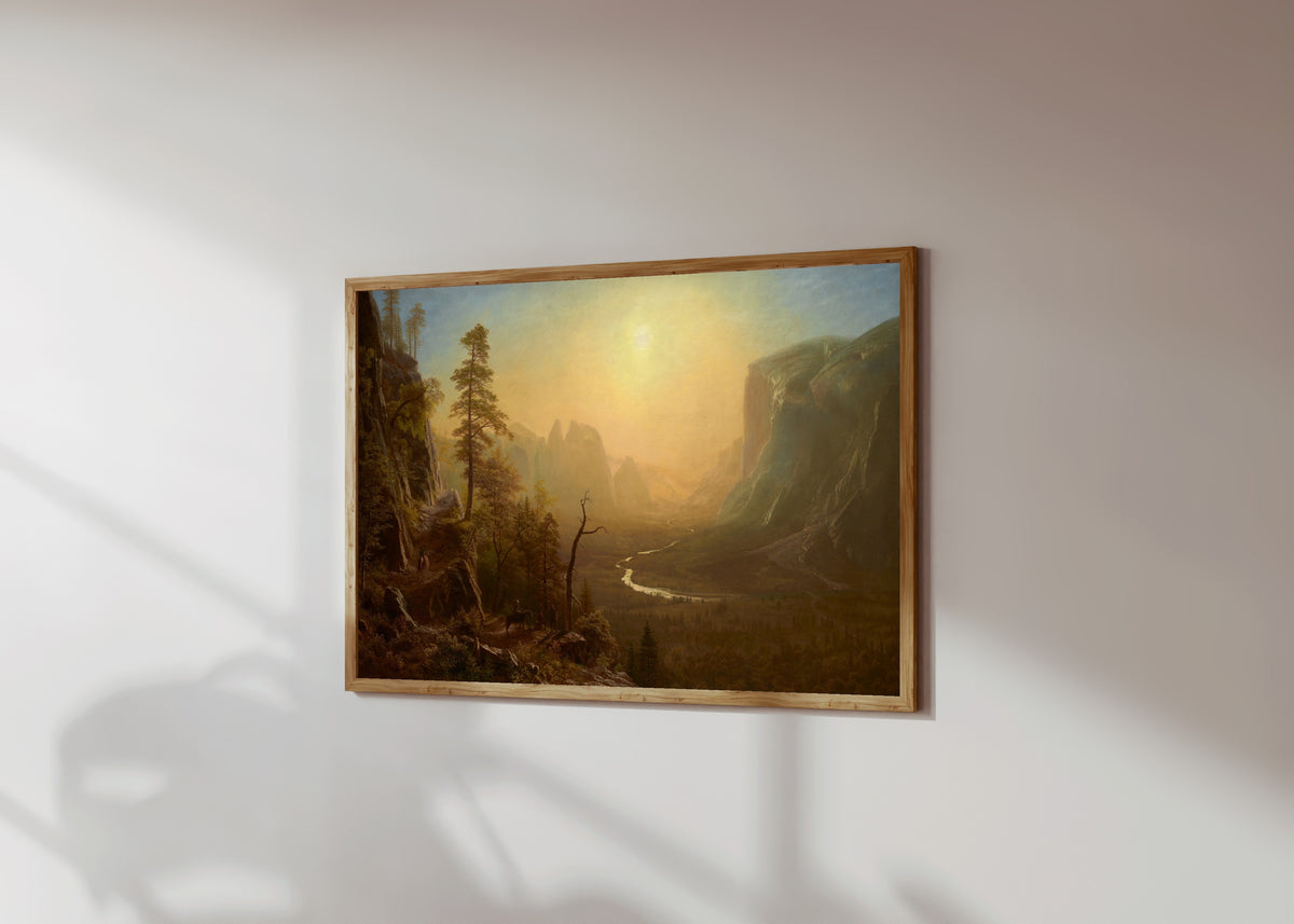 Framed art print of Yosemite Glacier Point Trail by Albert Bierstadt, in a light wood frame on a sunlit white wall, seen at a slight angle