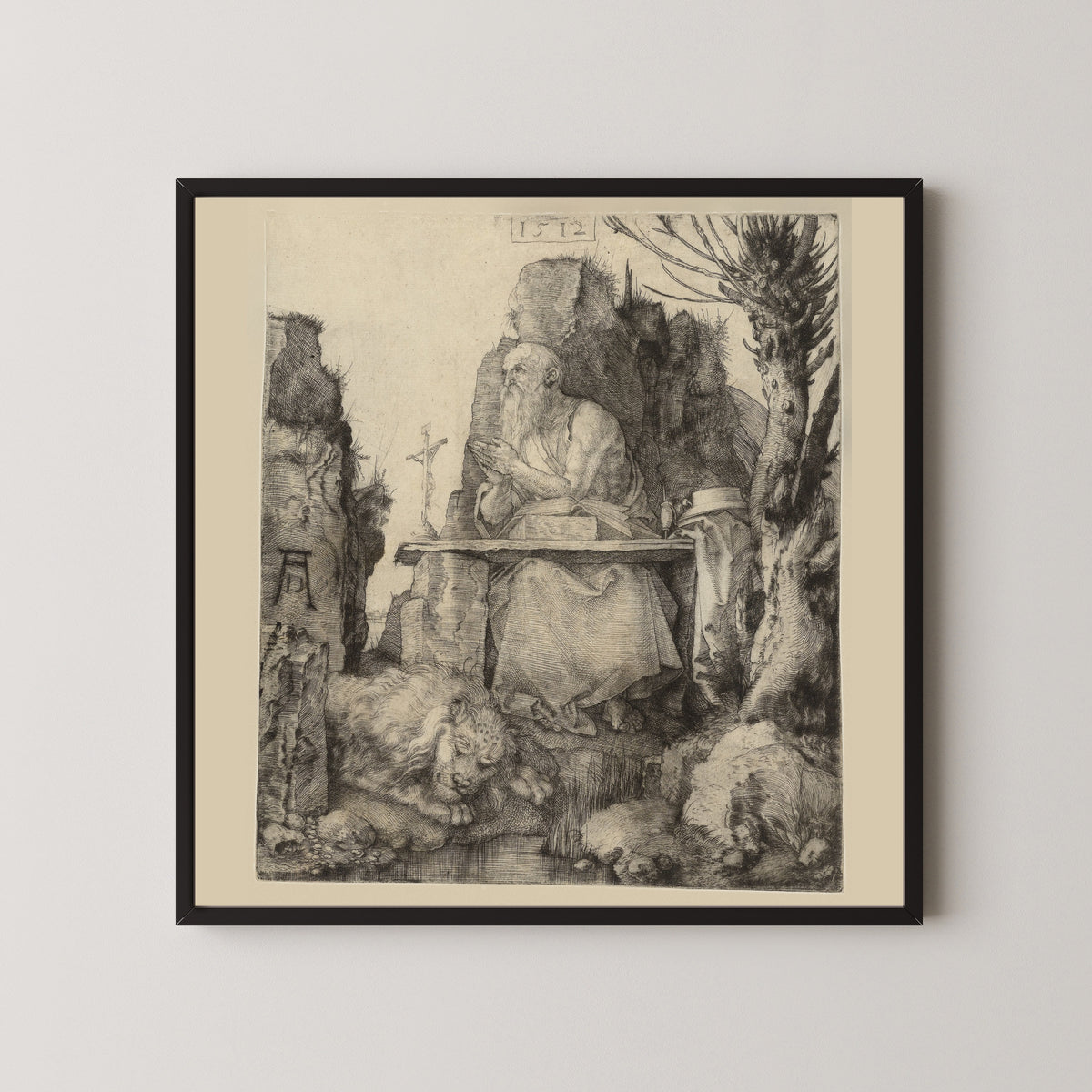 Framed art print of St Jerome in the Wilderness by Albrecht Dürer, in a black frame on a pale wall