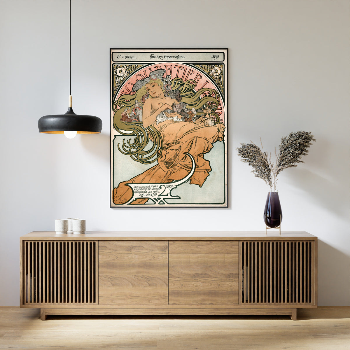 Framed art print of Au Quartier Latin by Alphonse Mucha, above a slatted wood sideboard