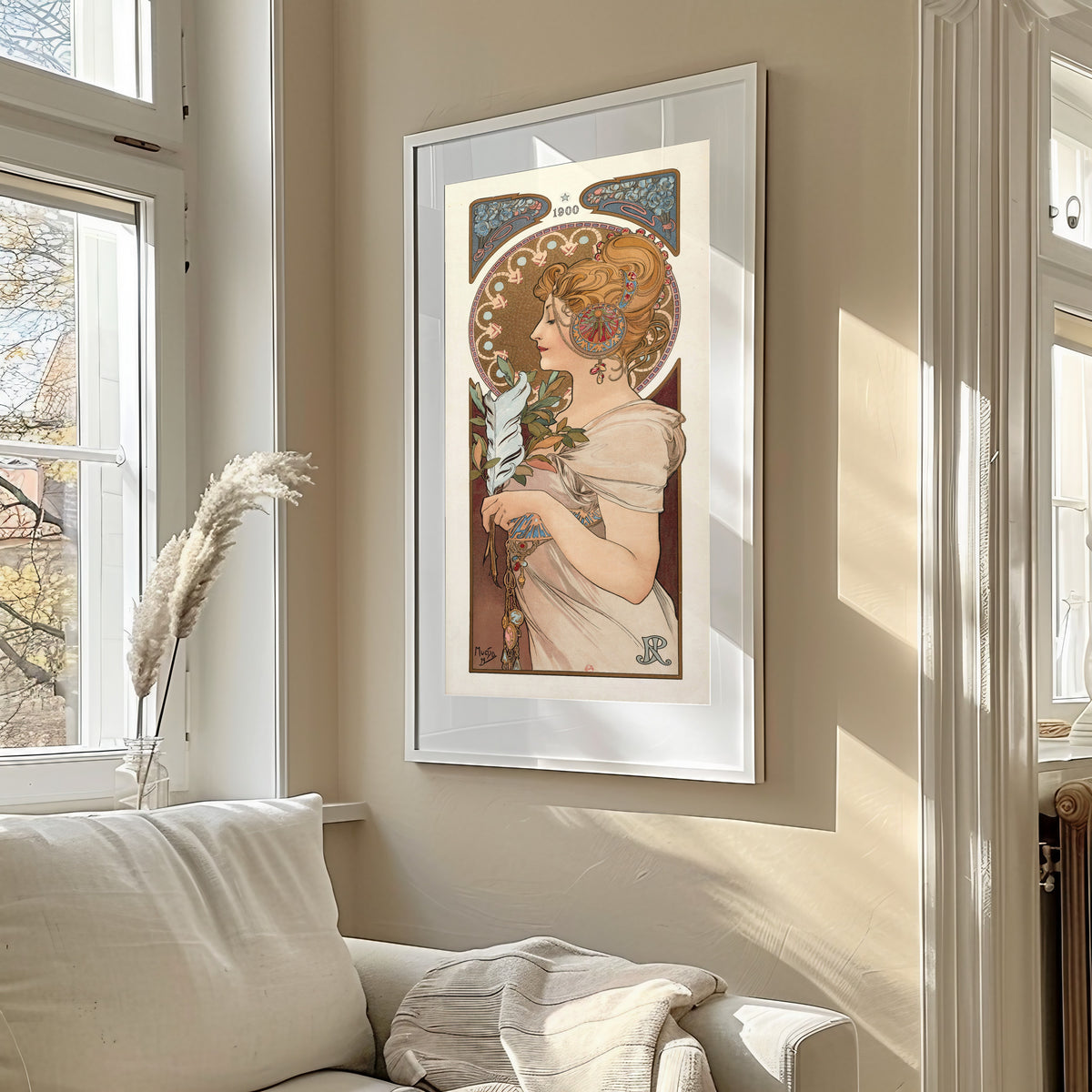 Framed art print of La Plume by Alphonse Mucha, in a sunlit living room above a sofa