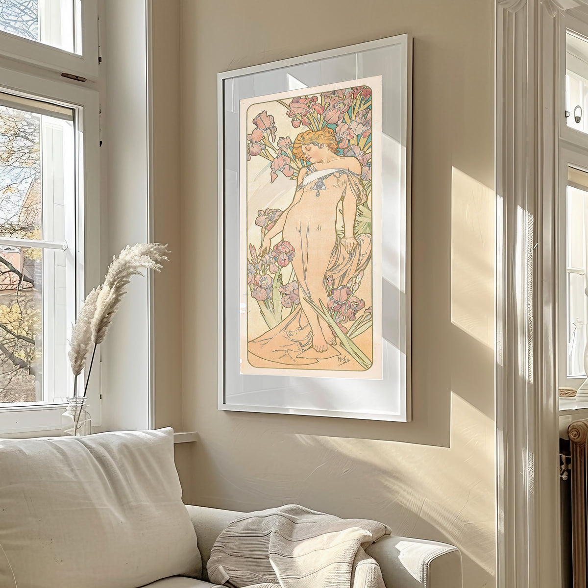 The Iris by Alphonse Mucha — framed in a sunlit living room above a sofa