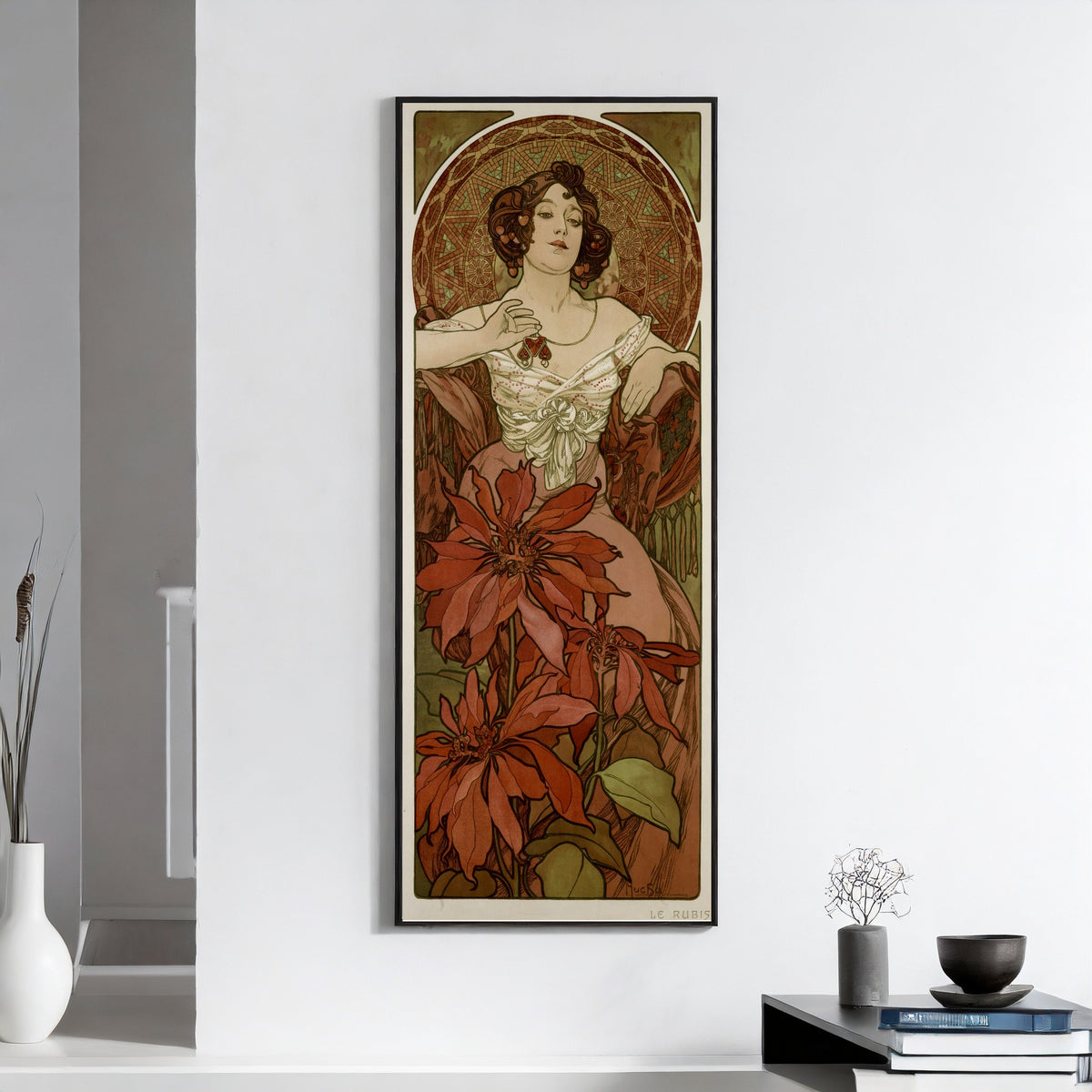 Framed art print of The Ruby by Alphonse Mucha, on a white wall above books and a bowl