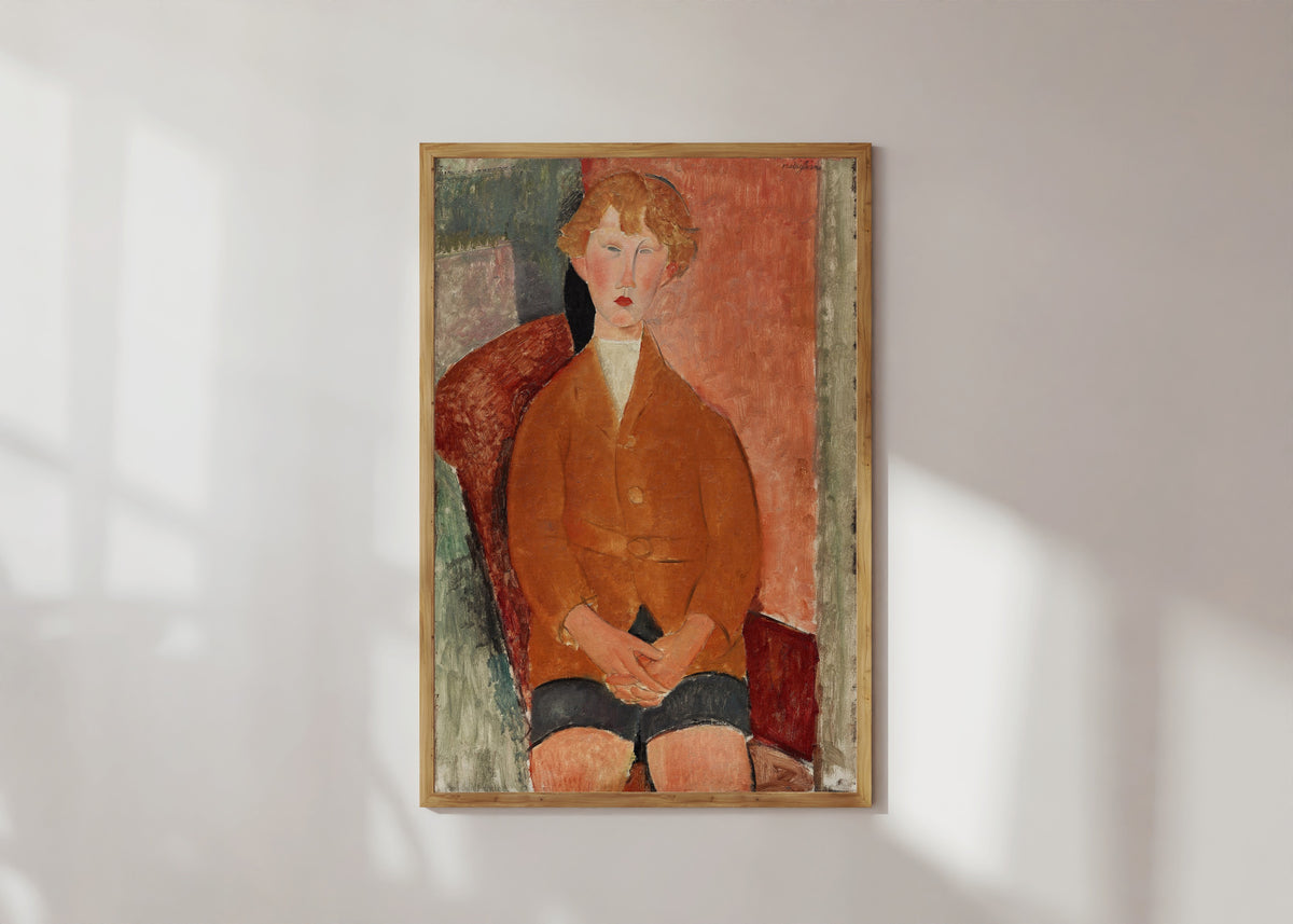 Framed art print of Boy in Short Pants by Amedeo Modigliani, in a light wood frame on a sunlit white wall