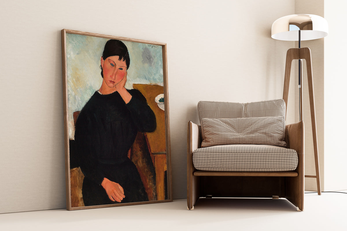 Elvira Resting at a Table by Amedeo Modigliani — framed and leaning against a wall beside an armchair and a floor lamp