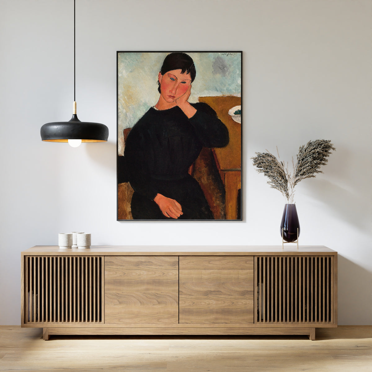 Elvira Resting at a Table by Amedeo Modigliani — framed above a slatted wood sideboard