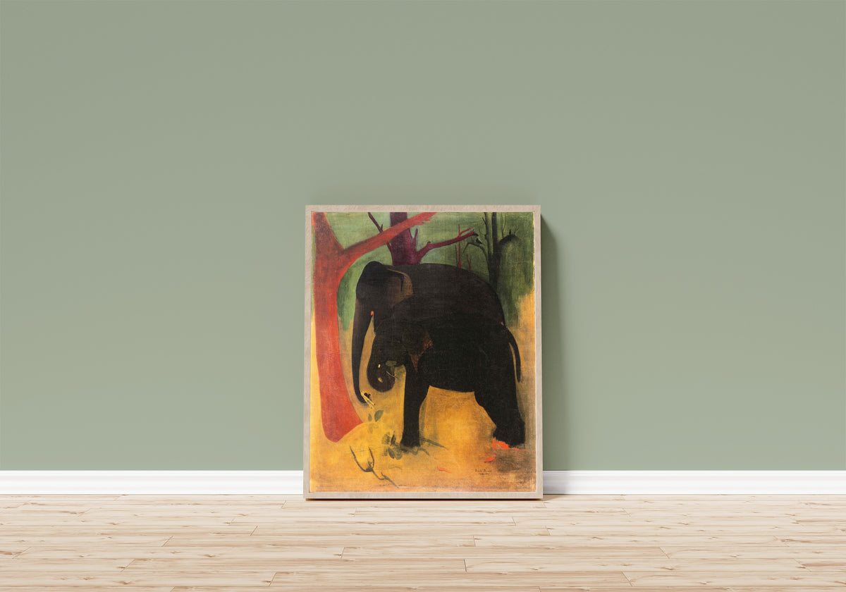 Framed art print of Elephants (1940) by Amrita Sher-Gil, in a light wood frame leaning on a sage green wall above a wooden floor
