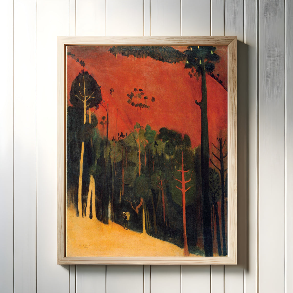 Framed art print of Hillside (1938) by Amrita Sher-Gil, in a light wood frame on a white panelled wall