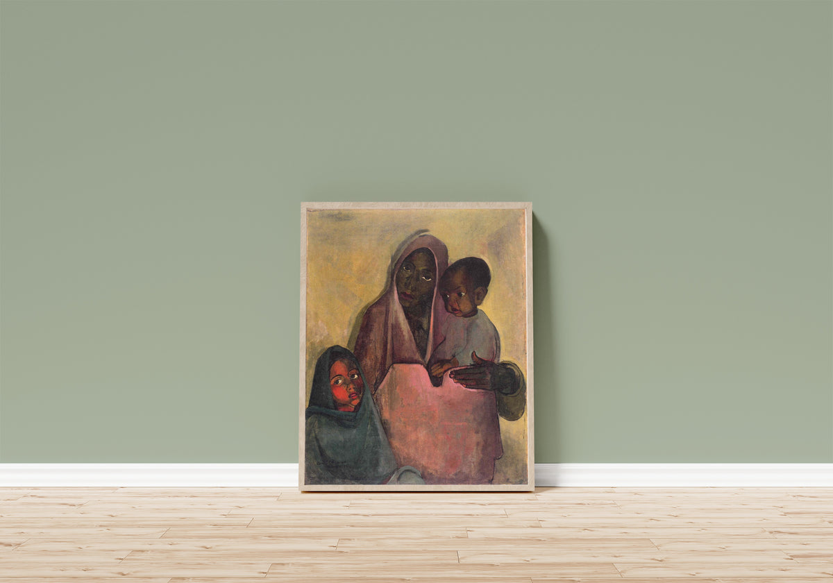 Framed art print of Mother India (1935) by Amrita Sher-Gil, in a light wood frame leaning on a sage green wall above a wooden floor