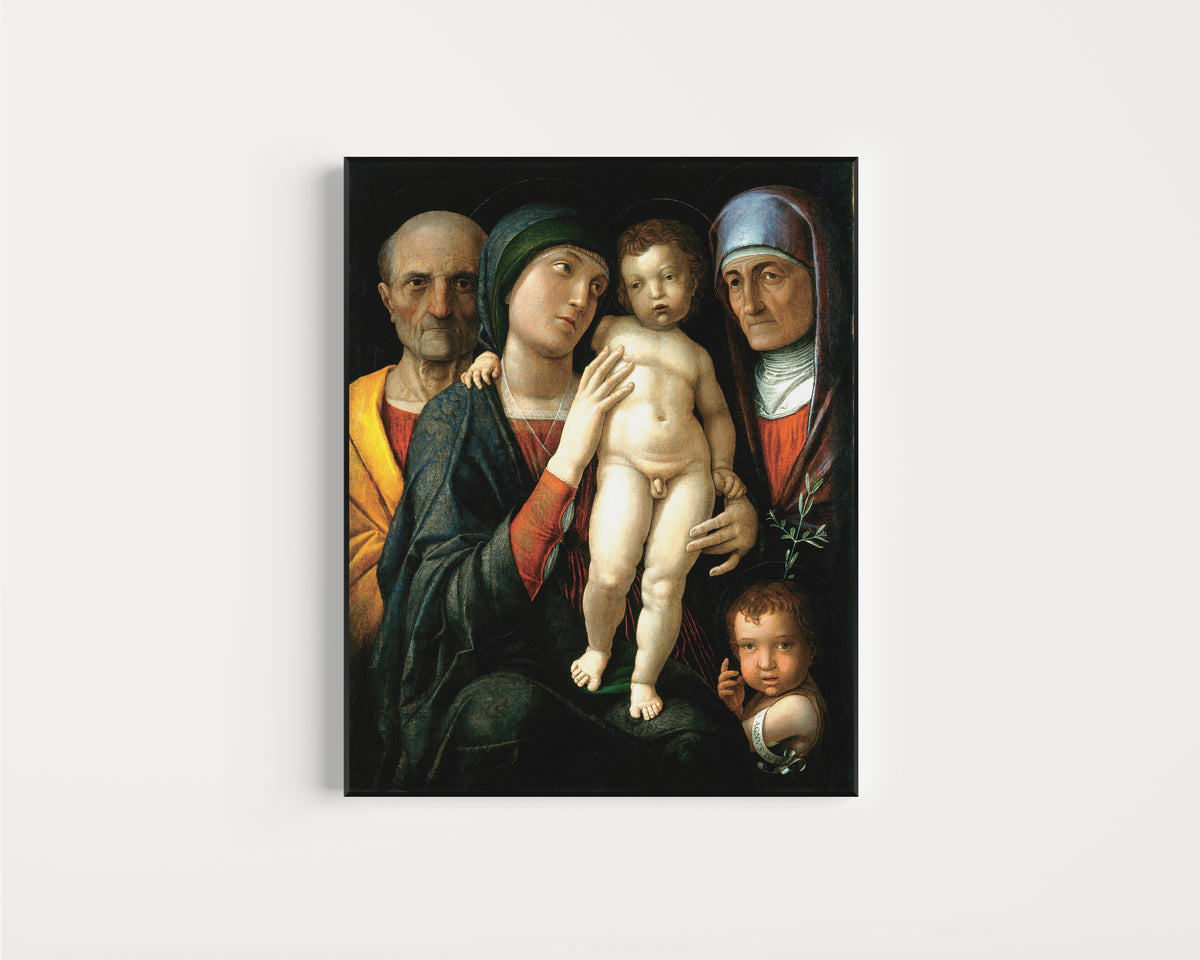 Framed art print of The Holy Family by Andrea Mantegna, in a slim black frame on a plain white wall