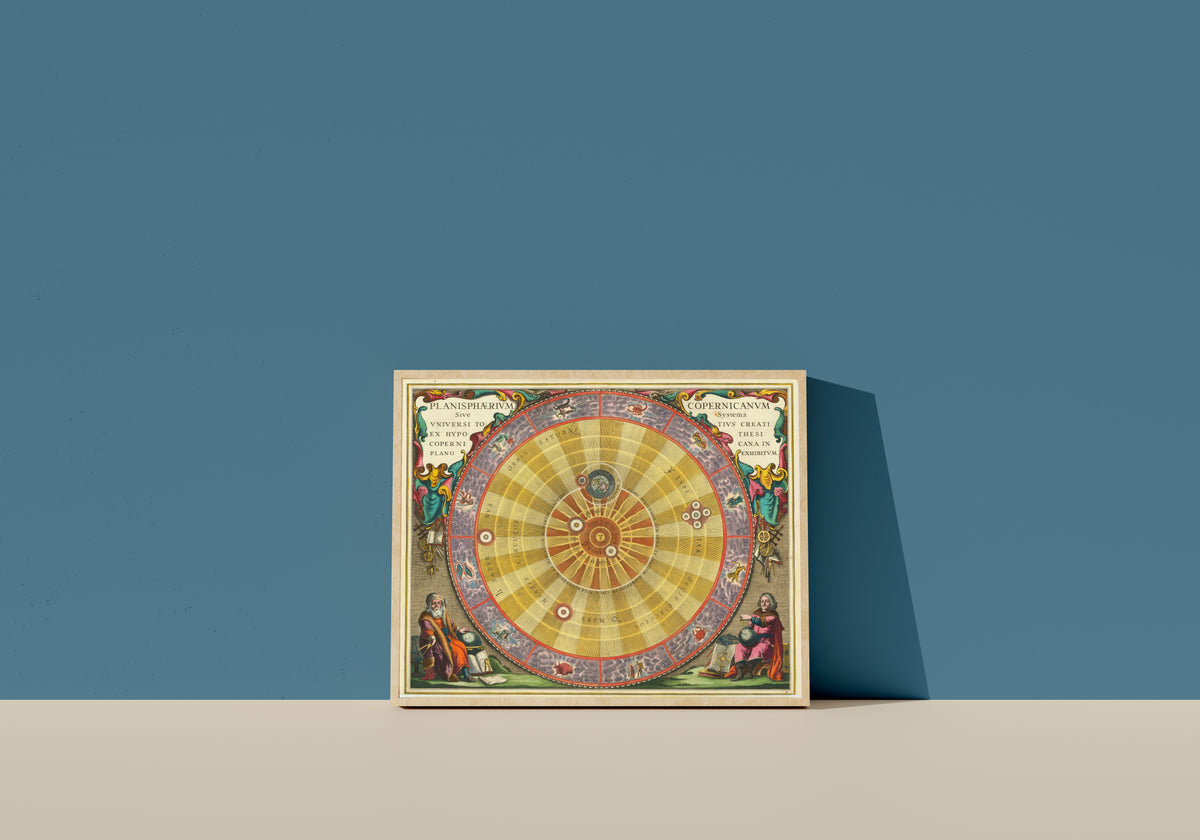 Framed art print of The Copernican Planisphere (Plate 4, Violet Colouring) by Andreas Cellarius, in a light wood frame leaning on a blue wall