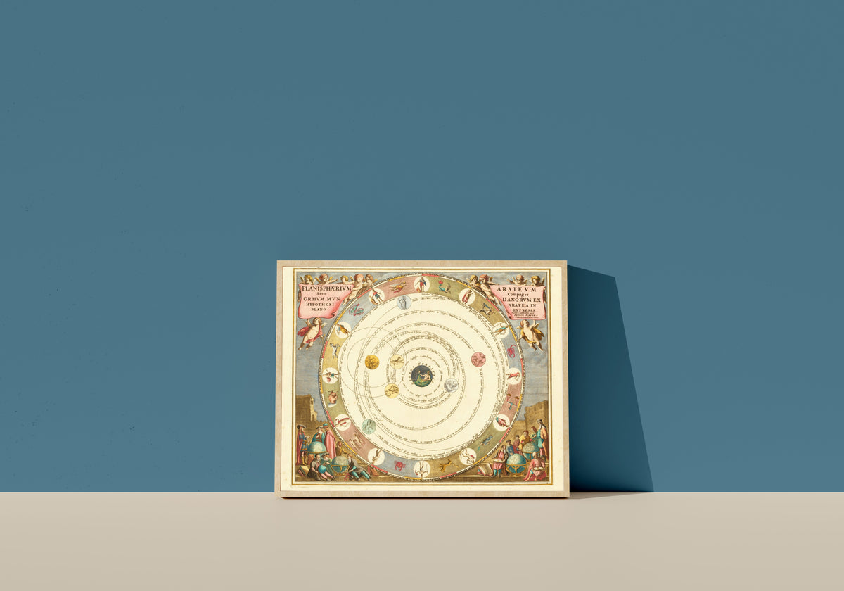 Framed art print of The Planisphere of Aratus (Plate 8, Azure Colouring) by Andreas Cellarius, in a light wood frame leaning on a blue wall