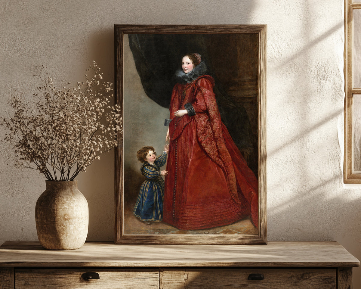 Framed art print of A Genoese Lady with Her Child by Anthony van Dyck, in a dark wood frame leaning on a rustic console beside dried flowers