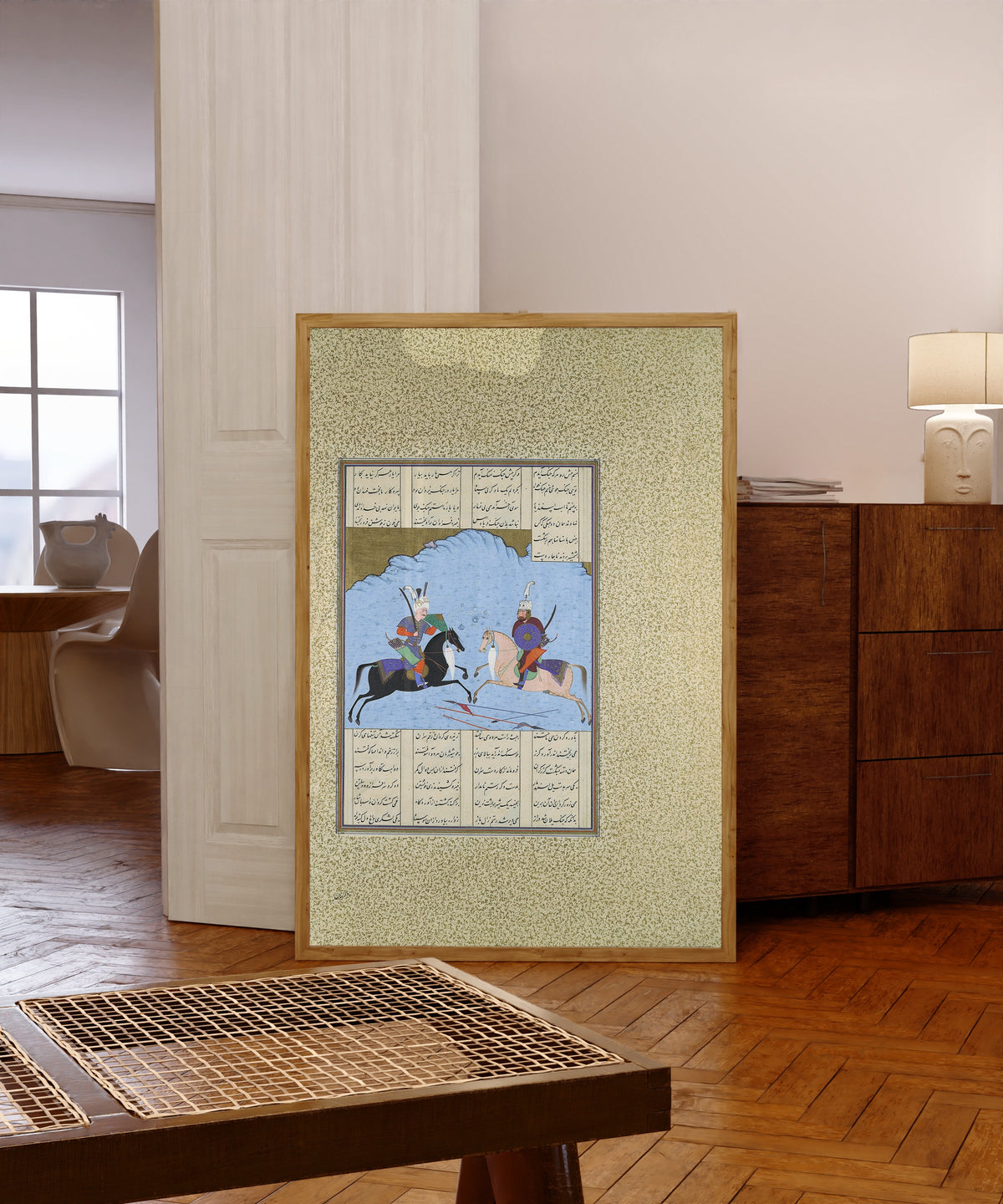 Framed art print of Shahnama of Shah Tahmasp: Rustam and… by Aqa Mirak (attributed), in a light wood frame leaning in a warm room with a parquet floor