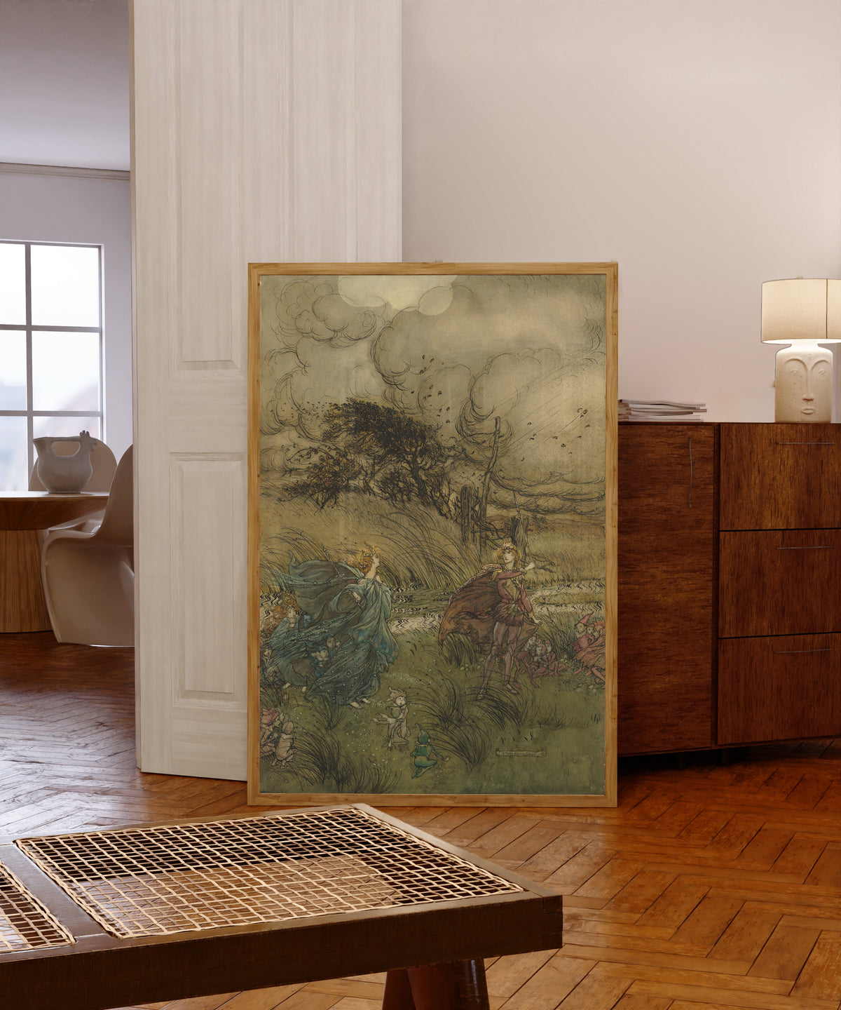 Framed art print of And Now They Never Meet in Grove or Green by Arthur Rackham, in a light wood frame leaning in a warm room with a parquet floor