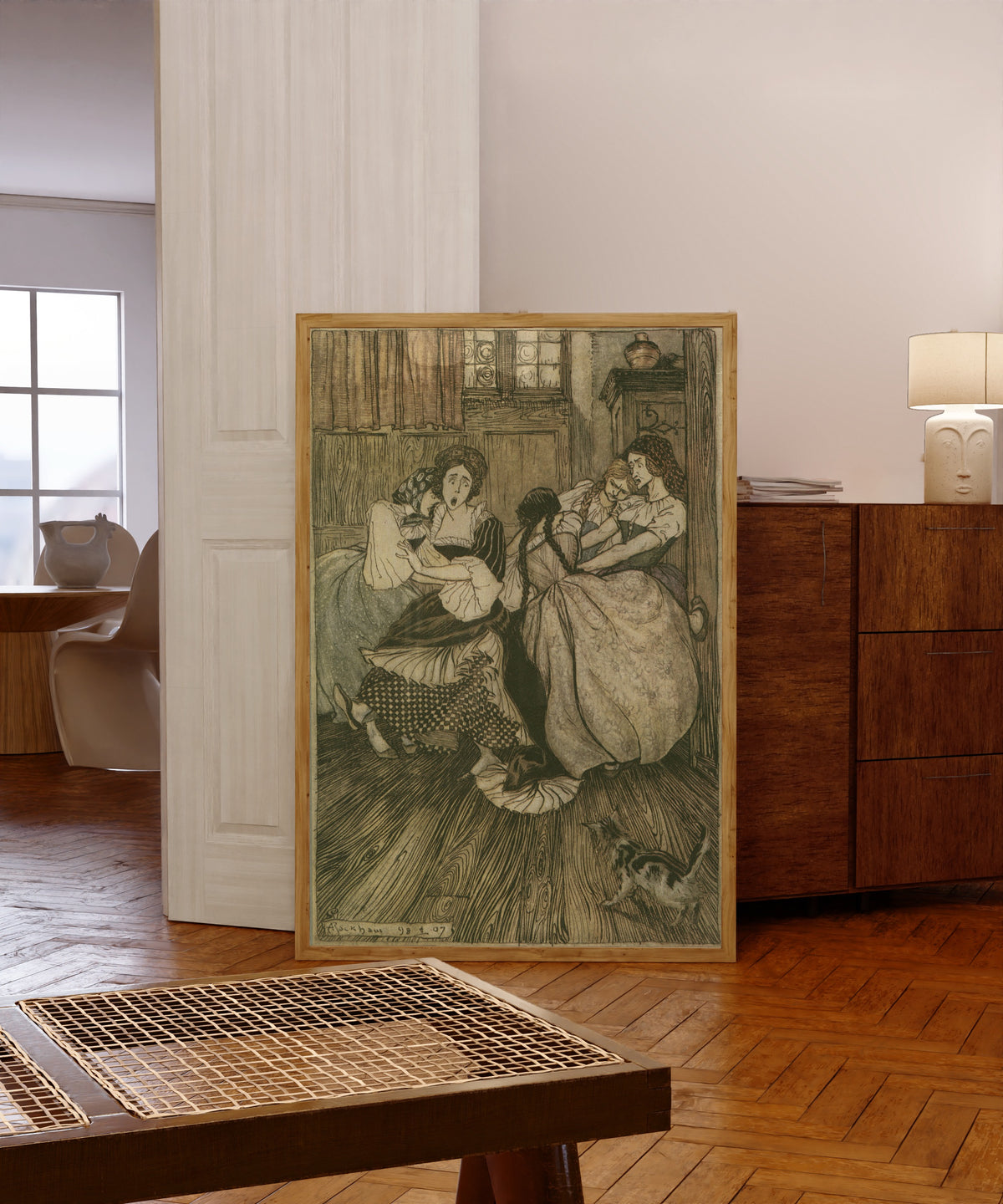 Framed art print of And the Maids Cried ‘Good Gracious, How Very… by Arthur Rackham, in a light wood frame leaning in a warm room with a parquet floor