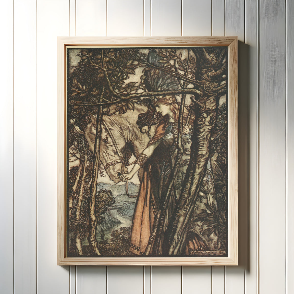 Framed art print of Brünnhilde Slowly and Silently Leads Her Horse Down the Path to the Cave by Arthur Rackham, in a light wood frame on a white panelled wall