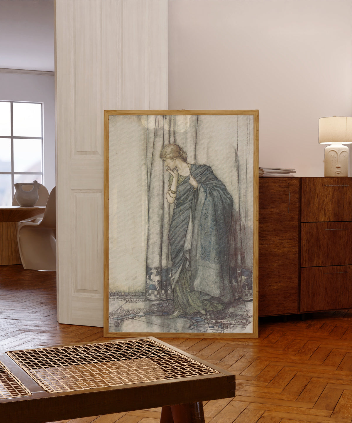Framed art print of Helena by Arthur Rackham, in a light wood frame leaning in a warm room with a parquet floor