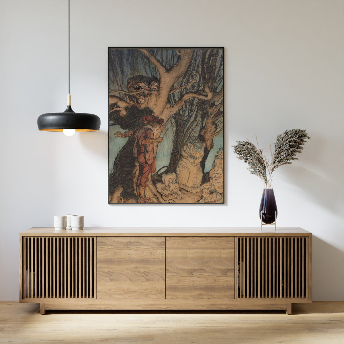 Framed art print of Instantly They Lay Still, All Turned into Stone by Arthur Rackham, above a slatted wood sideboard