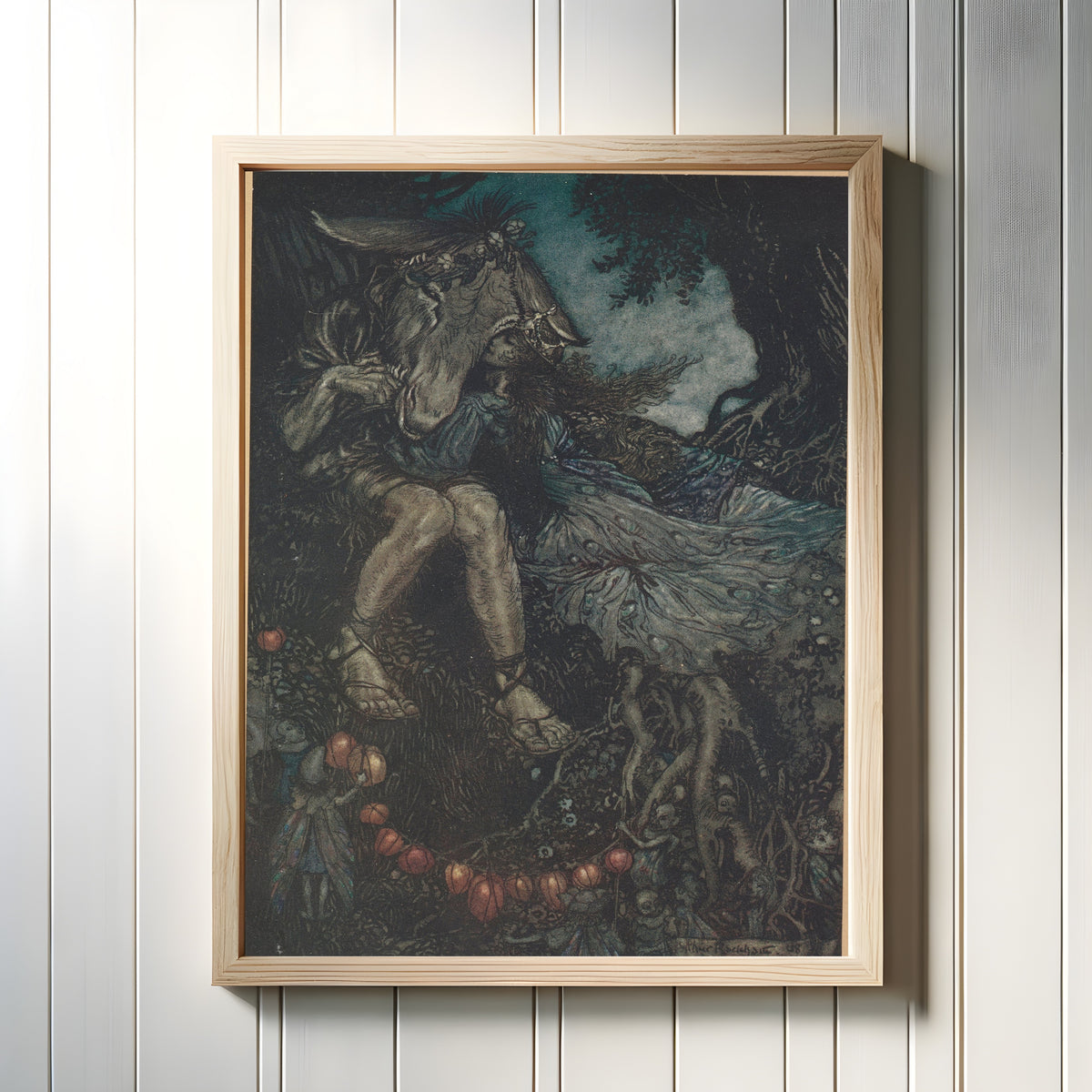Framed art print of Sleep Thou, and I Will Wind Thee in My Arms by Arthur Rackham, in a light wood frame on a white panelled wall
