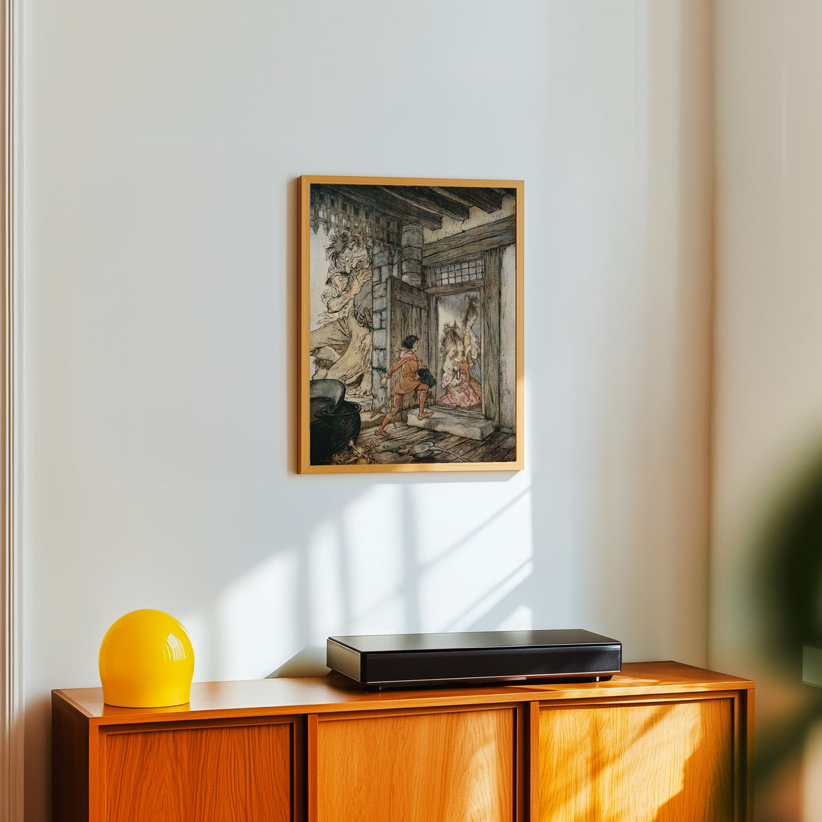 Framed art print of Taking the Keys of the Castle, Jack Unlocked All the… by Arthur Rackham, in a light wood frame on a white wall above an orange sideboard