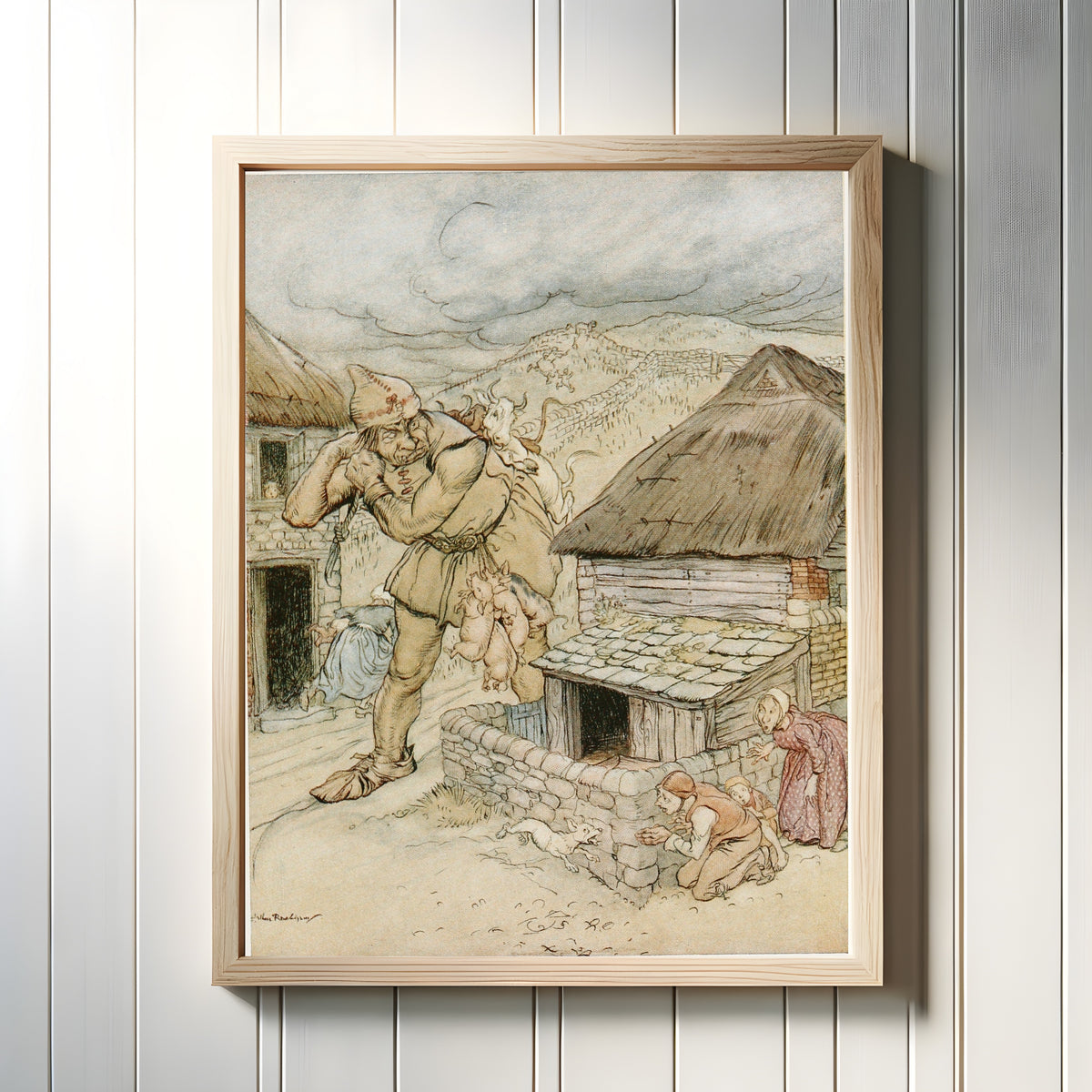 Framed art print of The Giant Cormoran Was the Terror of All the Country-Side by Arthur Rackham, in a light wood frame on a white panelled wall