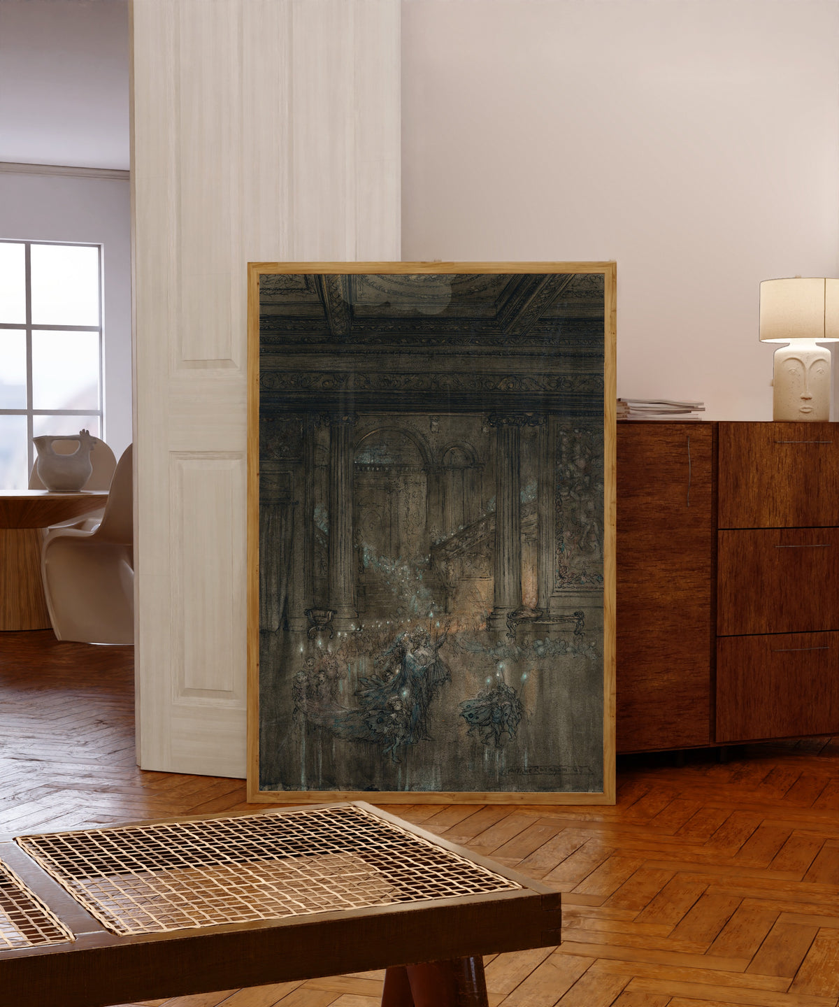Framed art print of Through the House Give Glimmering Light by Arthur Rackham, in a light wood frame leaning in a warm room with a parquet floor