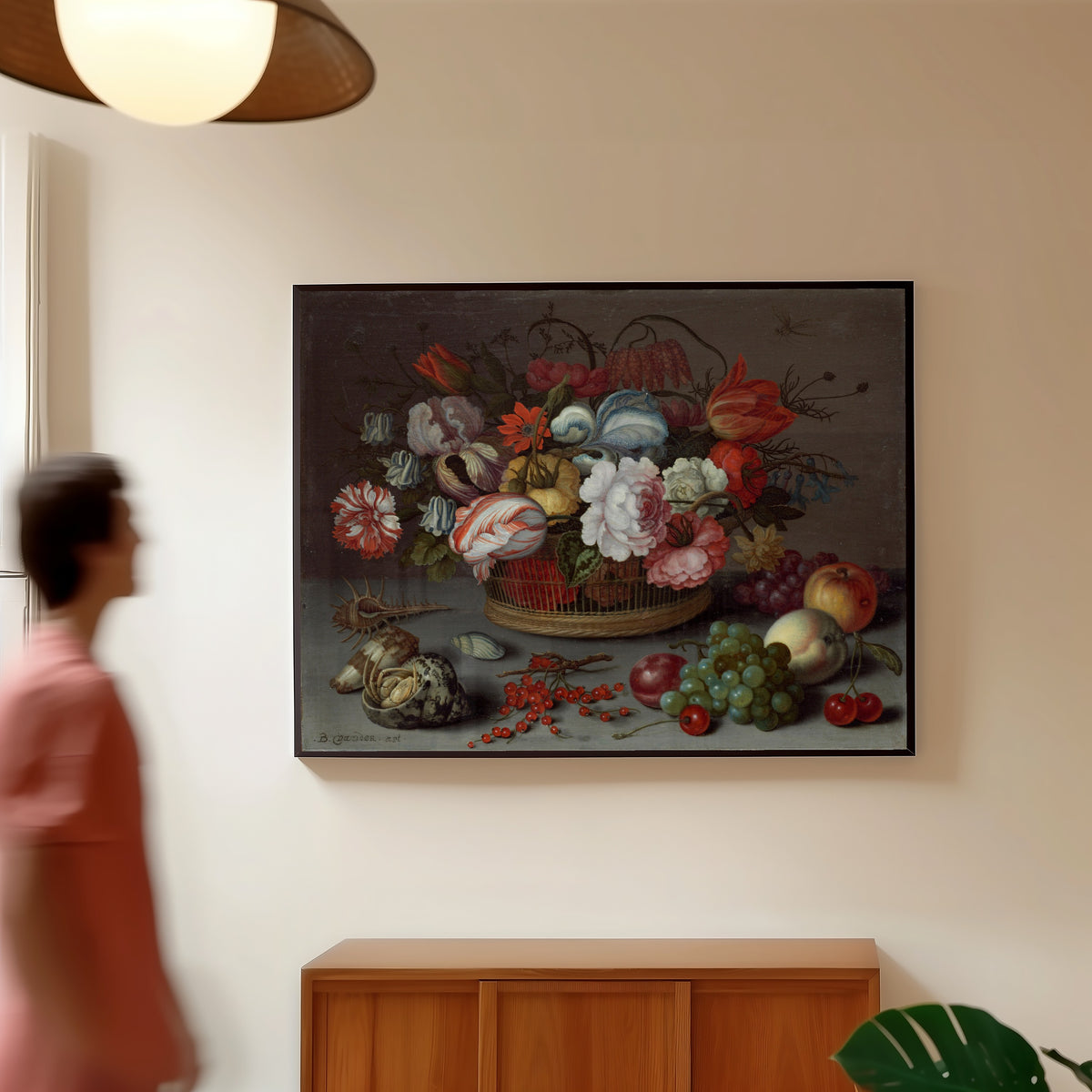 Framed art print of Basket of Flowers by Balthasar van der Ast, in a slim black frame on a warm wall in a sunlit room