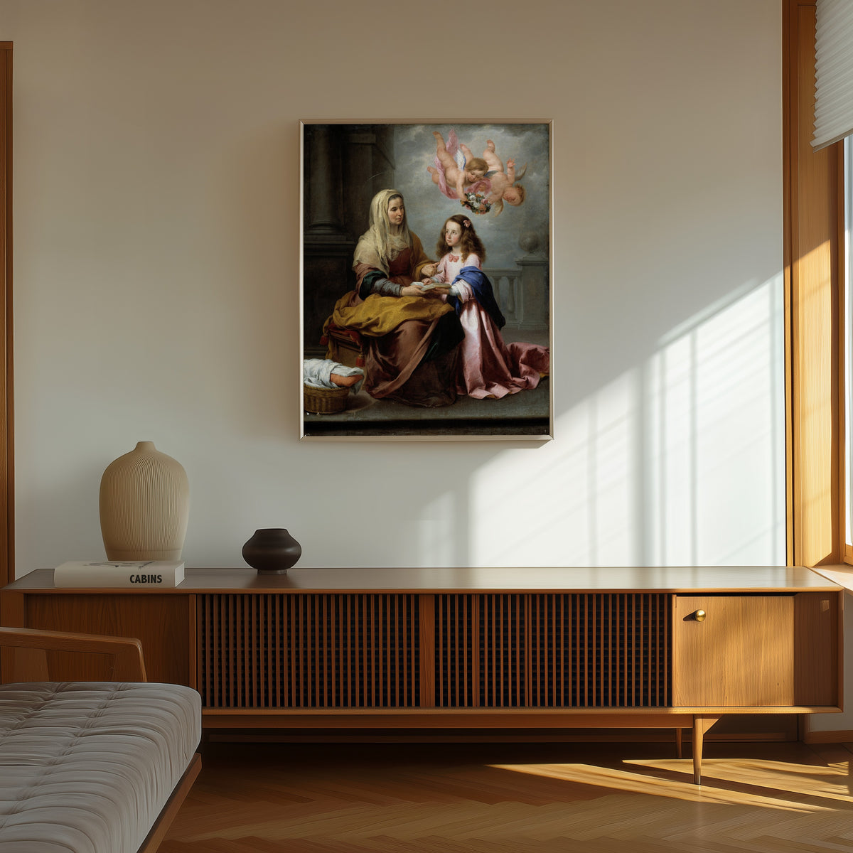 Framed art print of Saint Anne Teaching the Virgin to Read by Bartolomé Esteban Murillo, in a thin light frame on a sunlit wall above a wooden sideboard