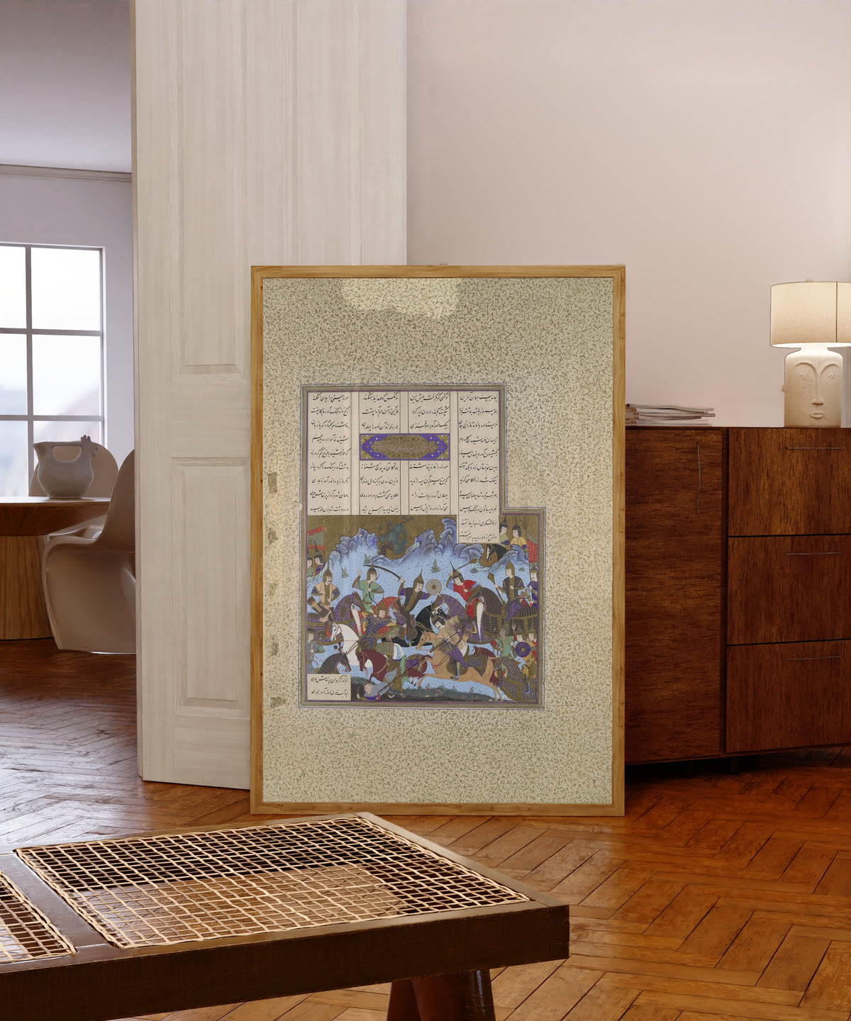 Framed art print of Shahnama of Shah Tahmasp: Sufarai's… by Bashdan Qara (attributed), in a light wood frame leaning in a warm room with a parquet floor