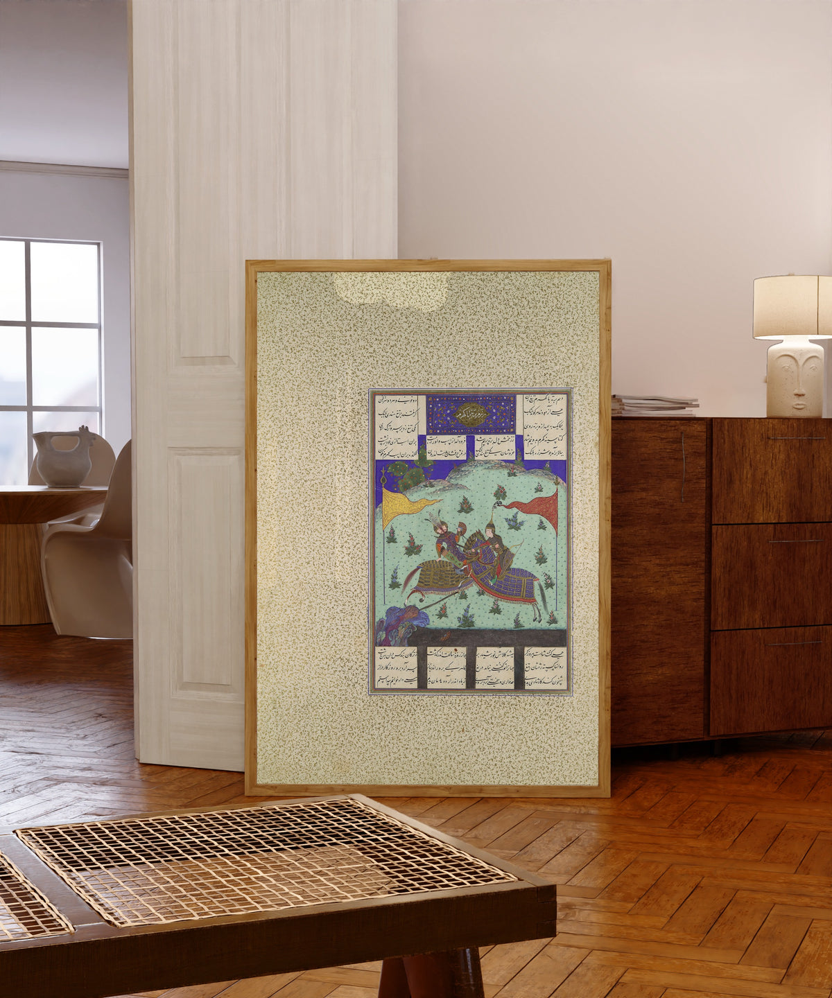 Framed art print of Shahnama of Shah Tahmasp: The Tenth Joust… by Bashdan Qara (attributed), in a light wood frame leaning in a warm room with a parquet floor
