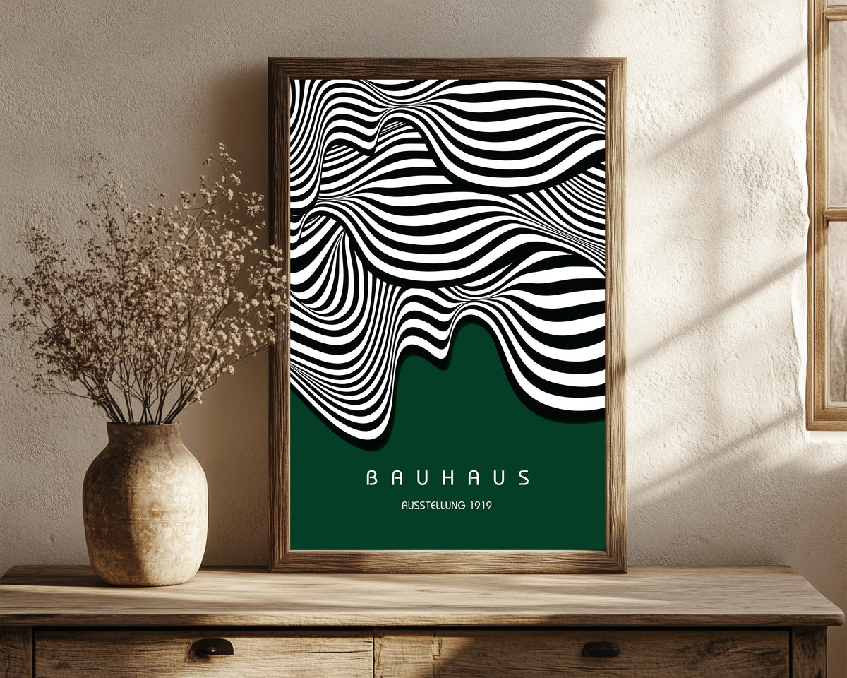 Framed art print of Ausstellung Waves by Bauhaus, in a dark wood frame leaning on a rustic console beside dried flowers