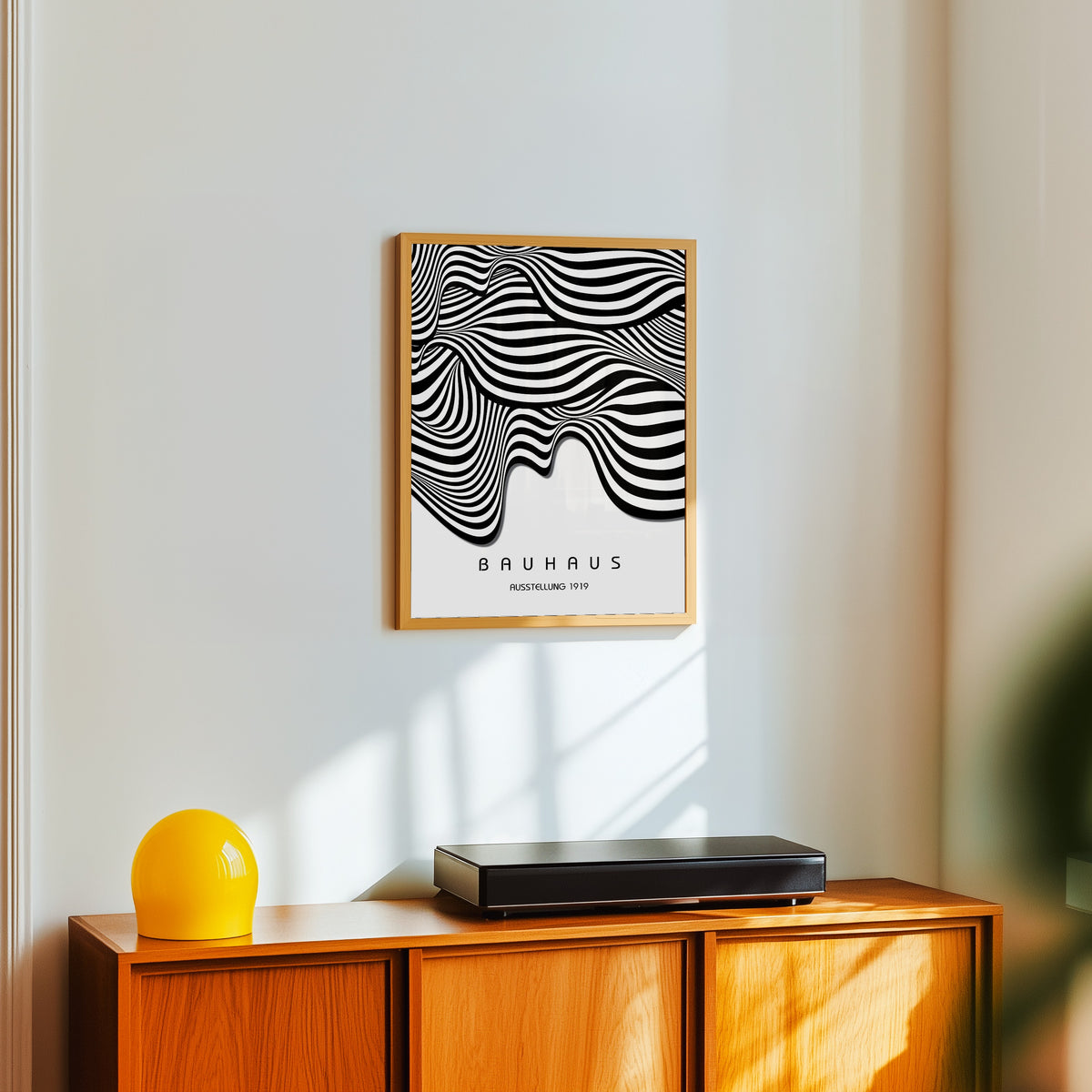Framed art print of Ausstellung Waves by Bauhaus, in a light wood frame on a white wall above an orange sideboard