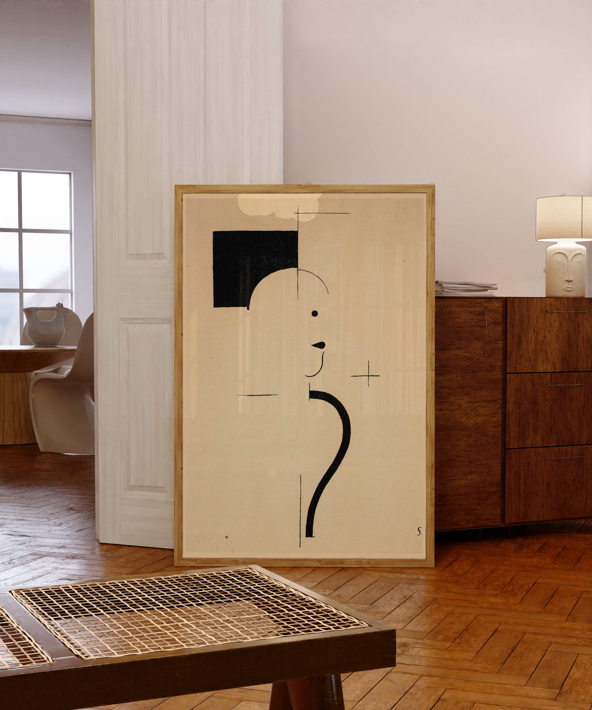 Framed art print of Vintage Poster by Bauhaus, in a light wood frame leaning in a warm room with a parquet floor