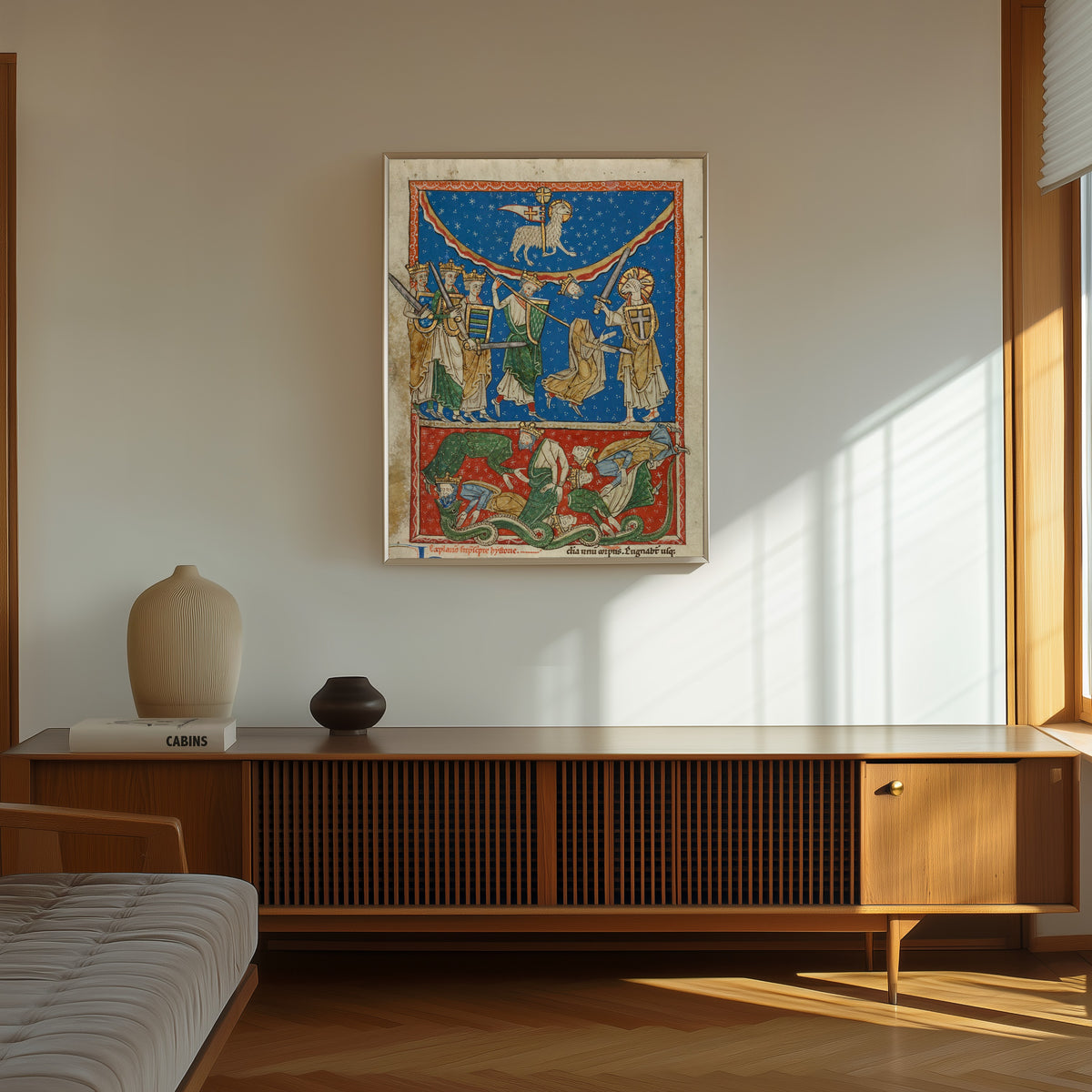 Framed art print of Beatus Manuscript: The Lamb Defeating the Ten Kings, in a thin light frame on a sunlit wall above a wooden sideboard