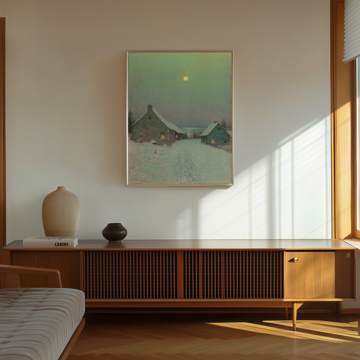 Framed art print of Christmas Eve by Birge Harrison, in a thin light frame on a sunlit wall above a wooden sideboard