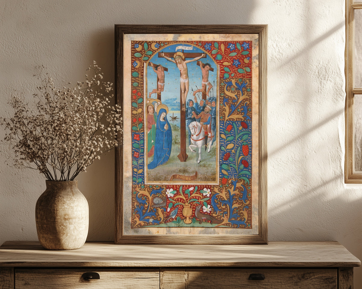 Framed art print of Book of Hours: The Crucifixion, in a dark wood frame leaning on a rustic console beside dried flowers