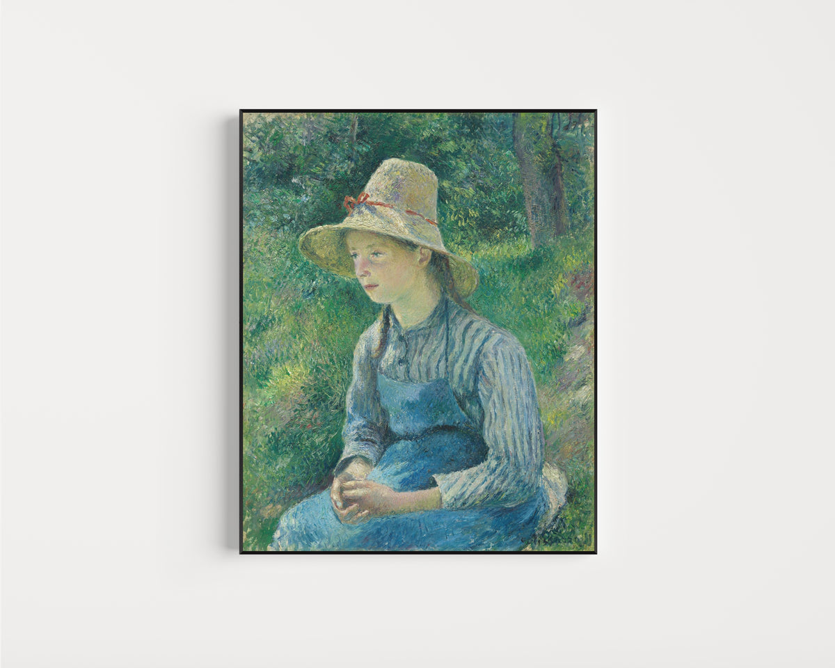 Framed art print of Peasant Girl with a Straw Hat by Camille Pissarro, in a slim black frame on a plain white wall