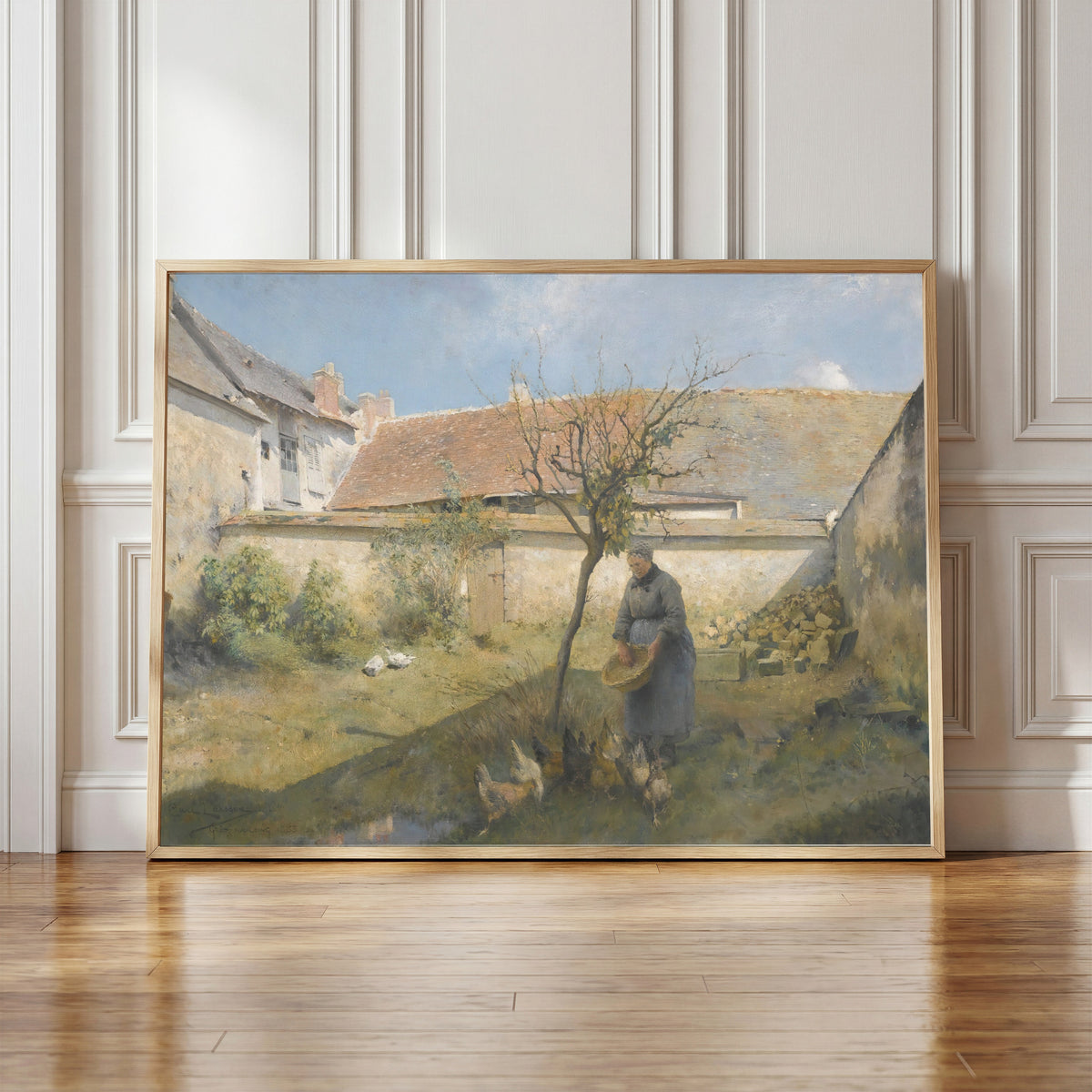 Framed art print of À la campagne by Carl Larsson, in a light wood frame leaning against a panelled white wall