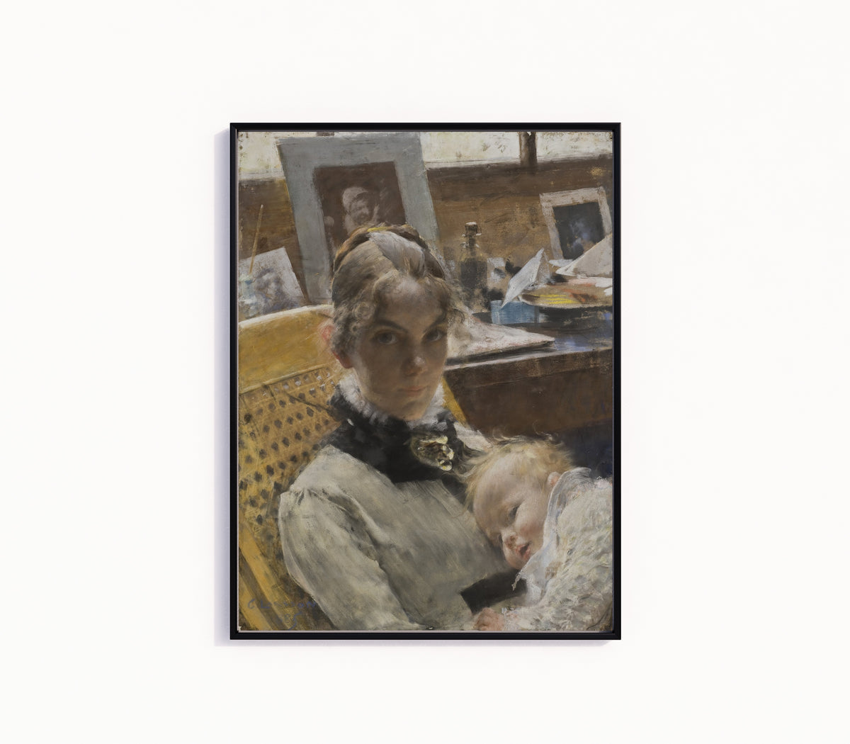 Framed art print of A Studio Idyll. The Artist's Wife and their Daughter by Carl Larsson, in a slim black frame on a plain white wall