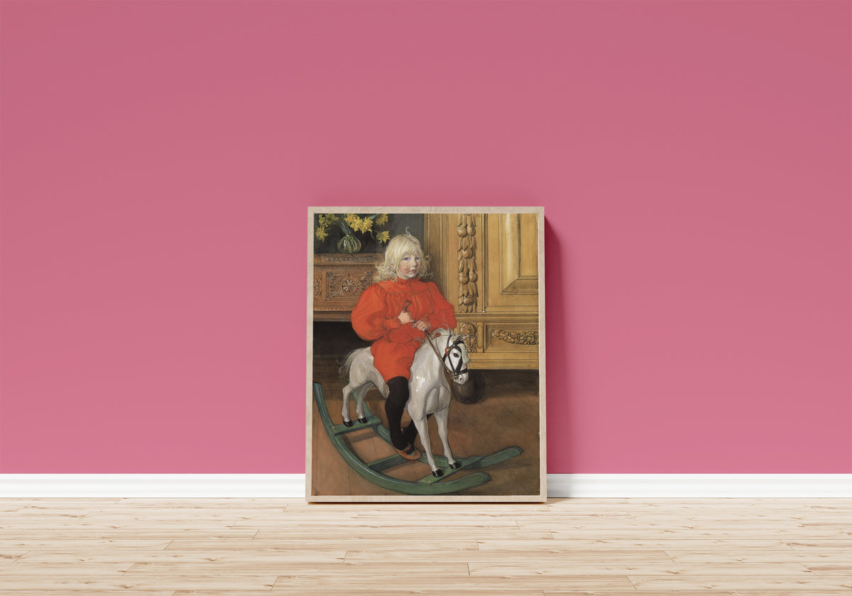 Framed art print of Murre: Portrait of Casimir Laurin by Carl Larsson, in a light wood frame leaning on a pink wall above a wooden floor