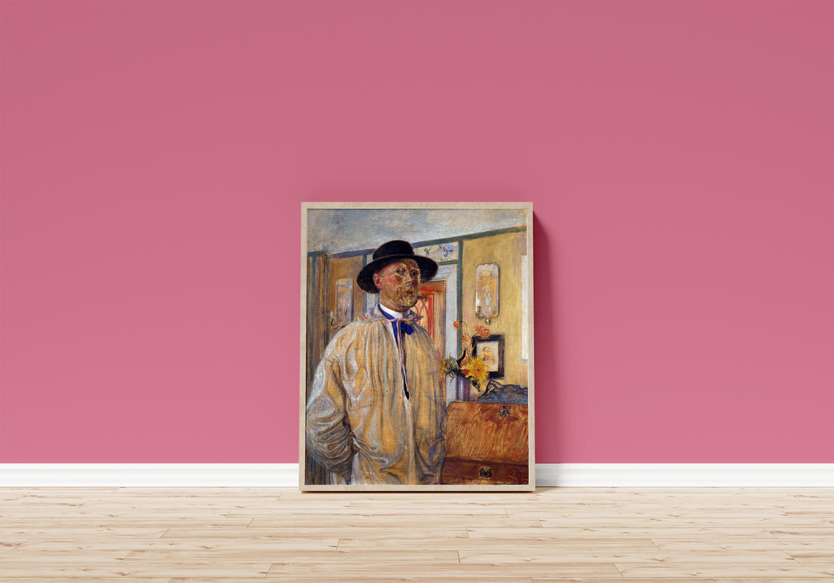 Framed art print of Self-Portrait by Carl Larsson, in a light wood frame leaning on a pink wall above a wooden floor