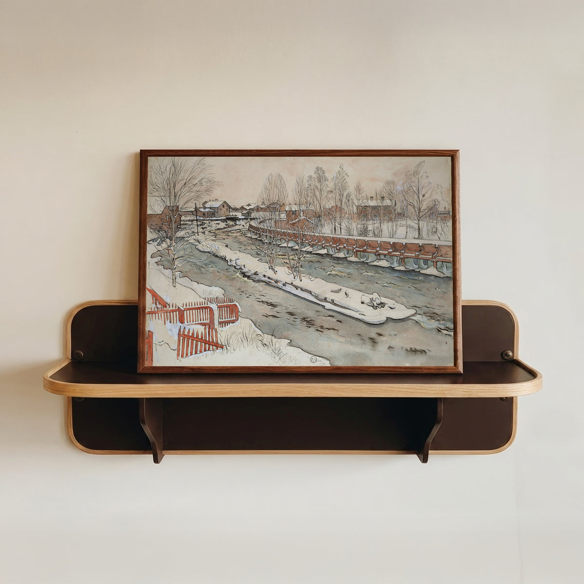 Framed art print of The Timber Chute. Winterscene by Carl Larsson, in a dark wood frame resting on a wall shelf