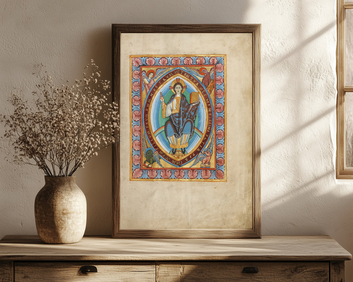 Framed art print of Christ in Majesty, in a dark wood frame leaning on a rustic console beside dried flowers